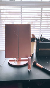 You will absolutely love this rose gold makeup mirror with magnifying mirrors on the side.