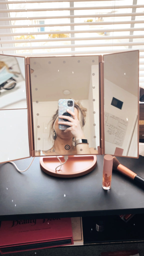 You will absolutely love this rose gold makeup mirror with magnifying mirrors on the side.